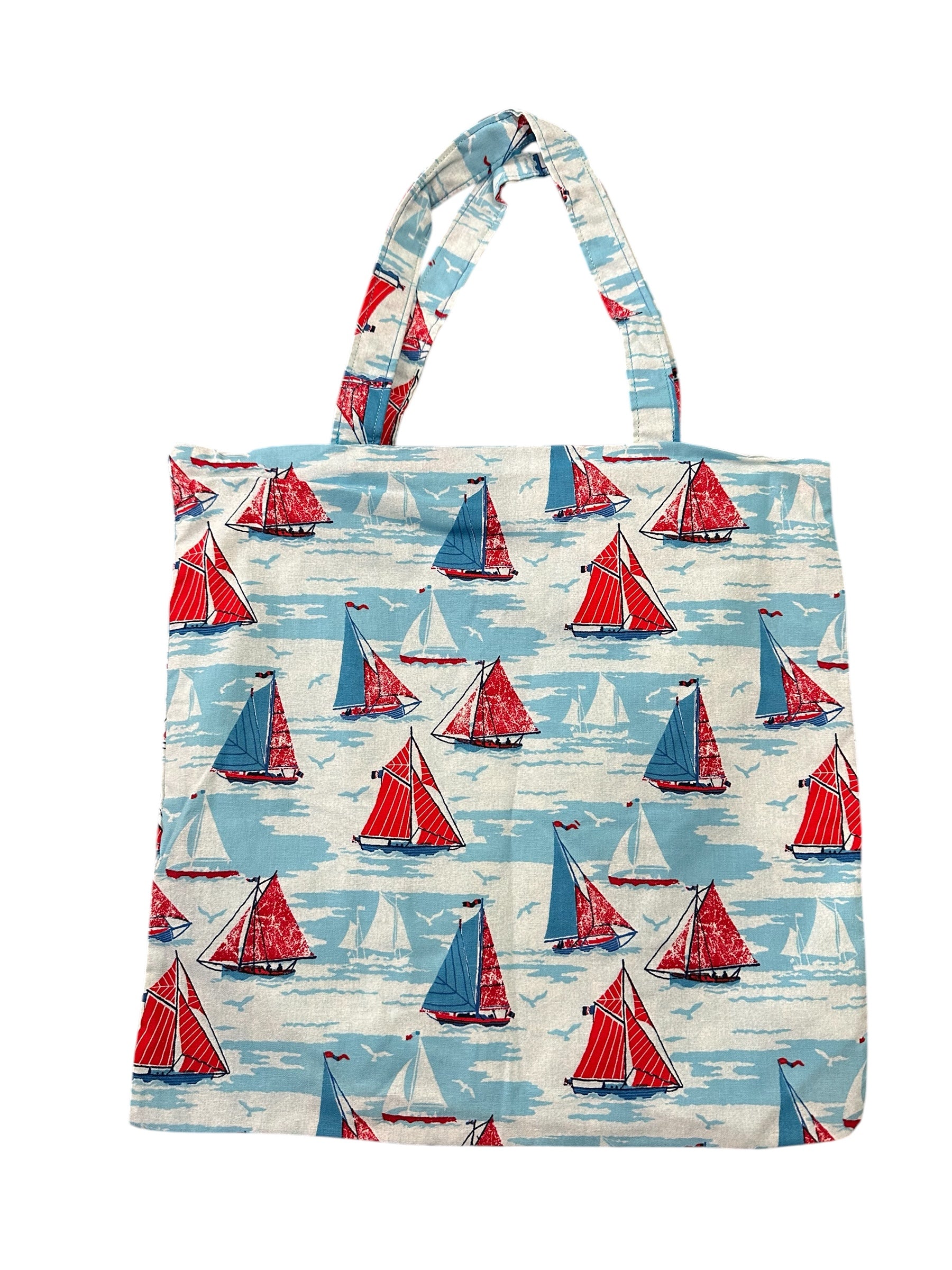Tote bag with red and blue sailboat pattern on a white background
