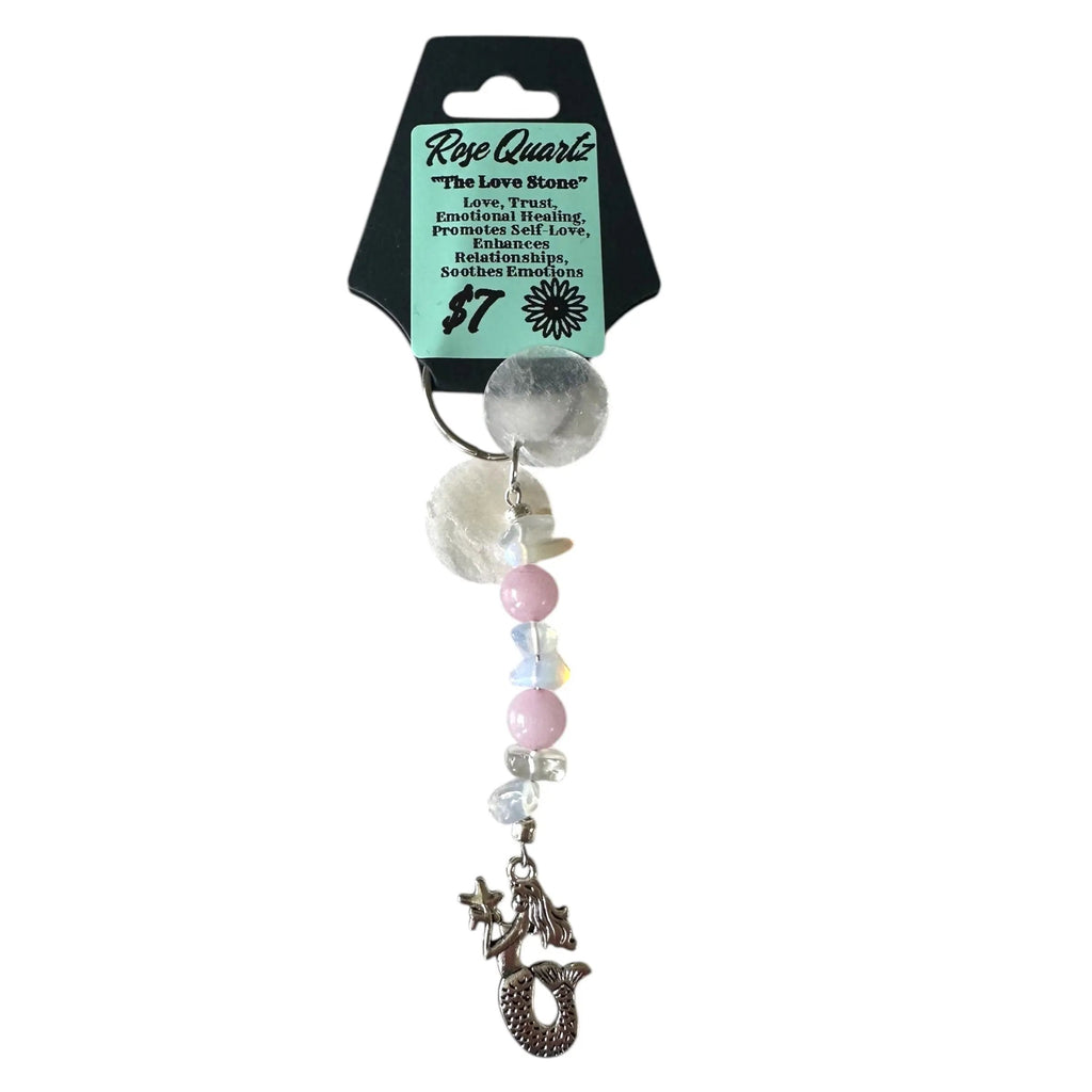 Decorative keychain with beads and a charm on a white background