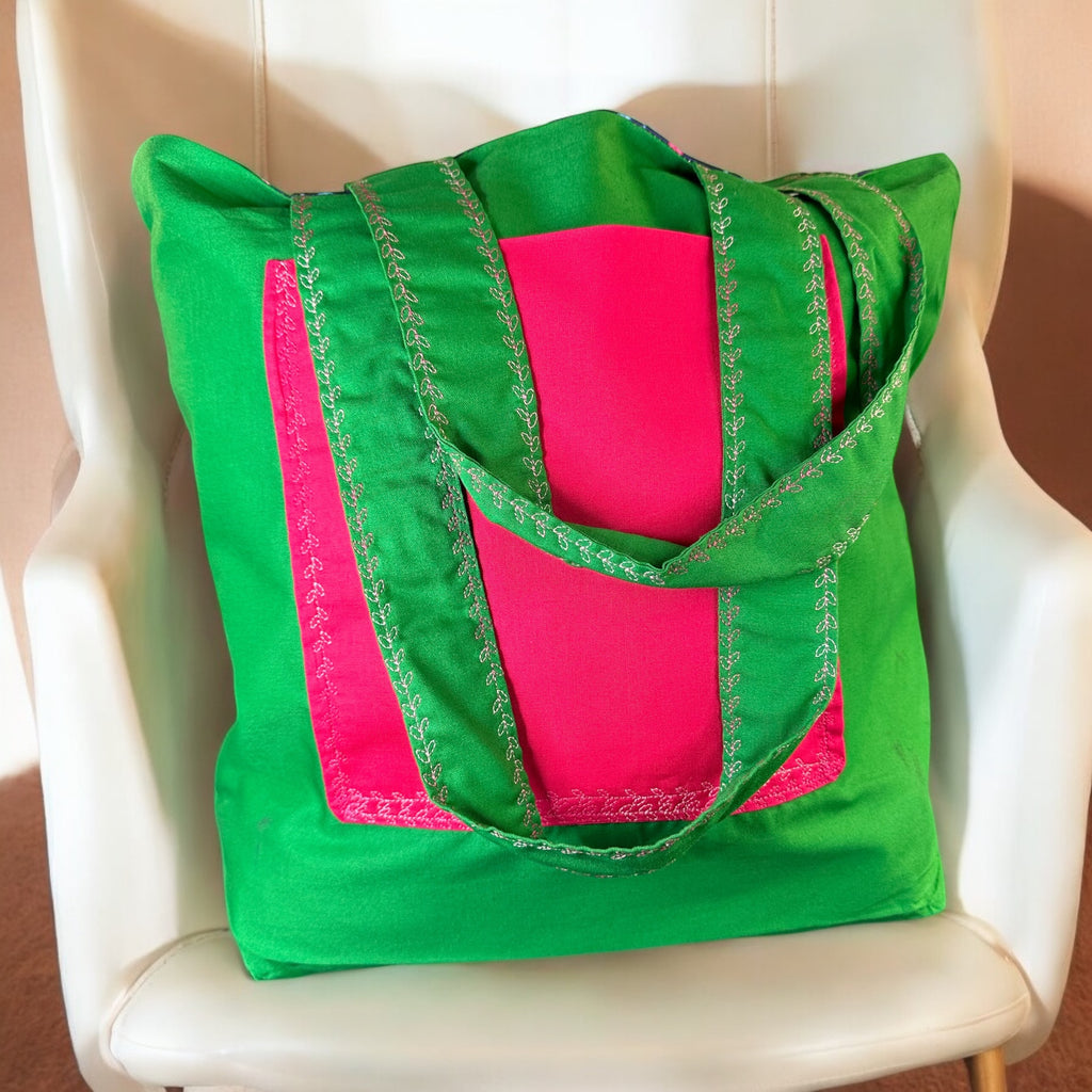 Green and pink tote bag on a white chair
