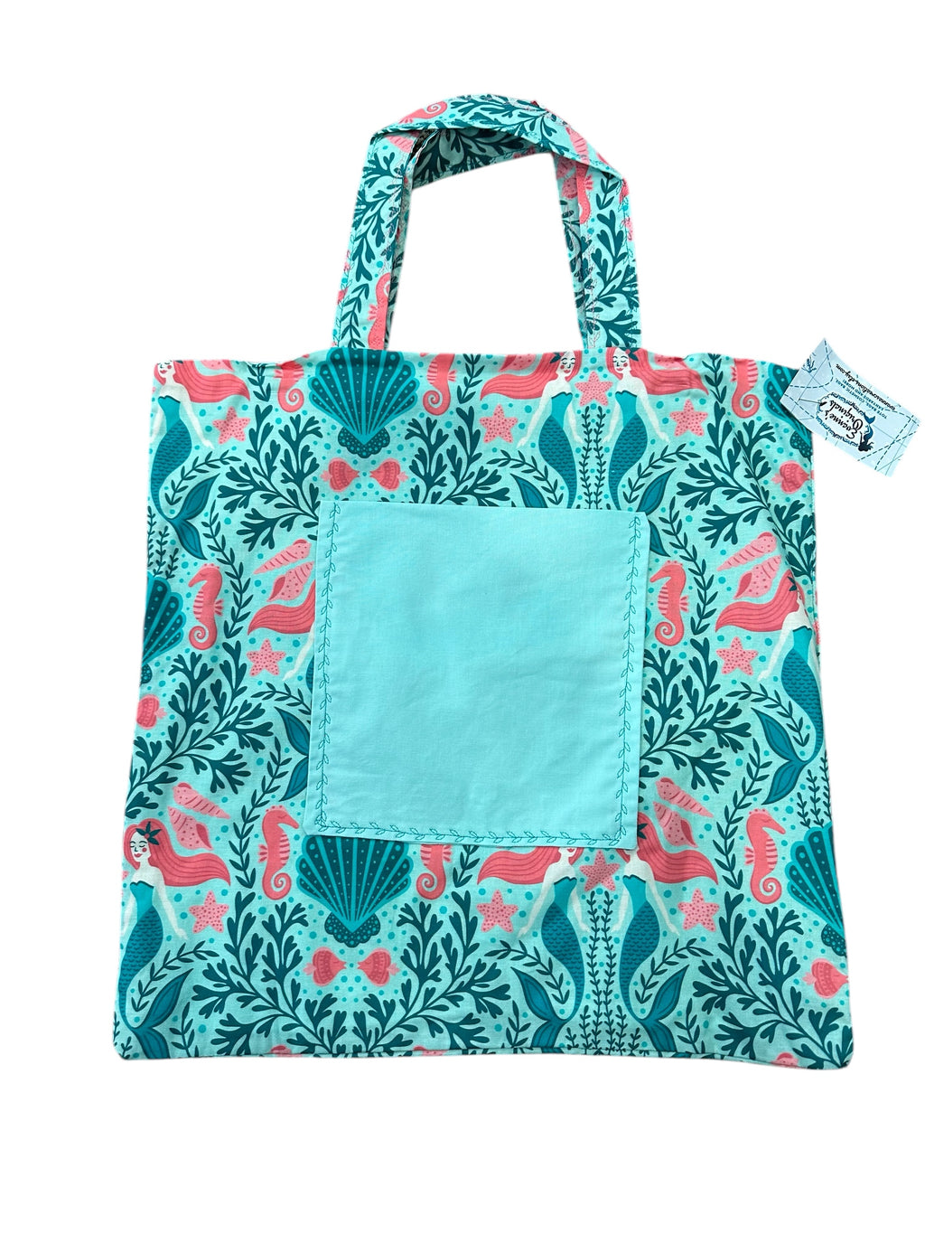 Reusable shopping bag with mermaid and sea shell pattern on a white background