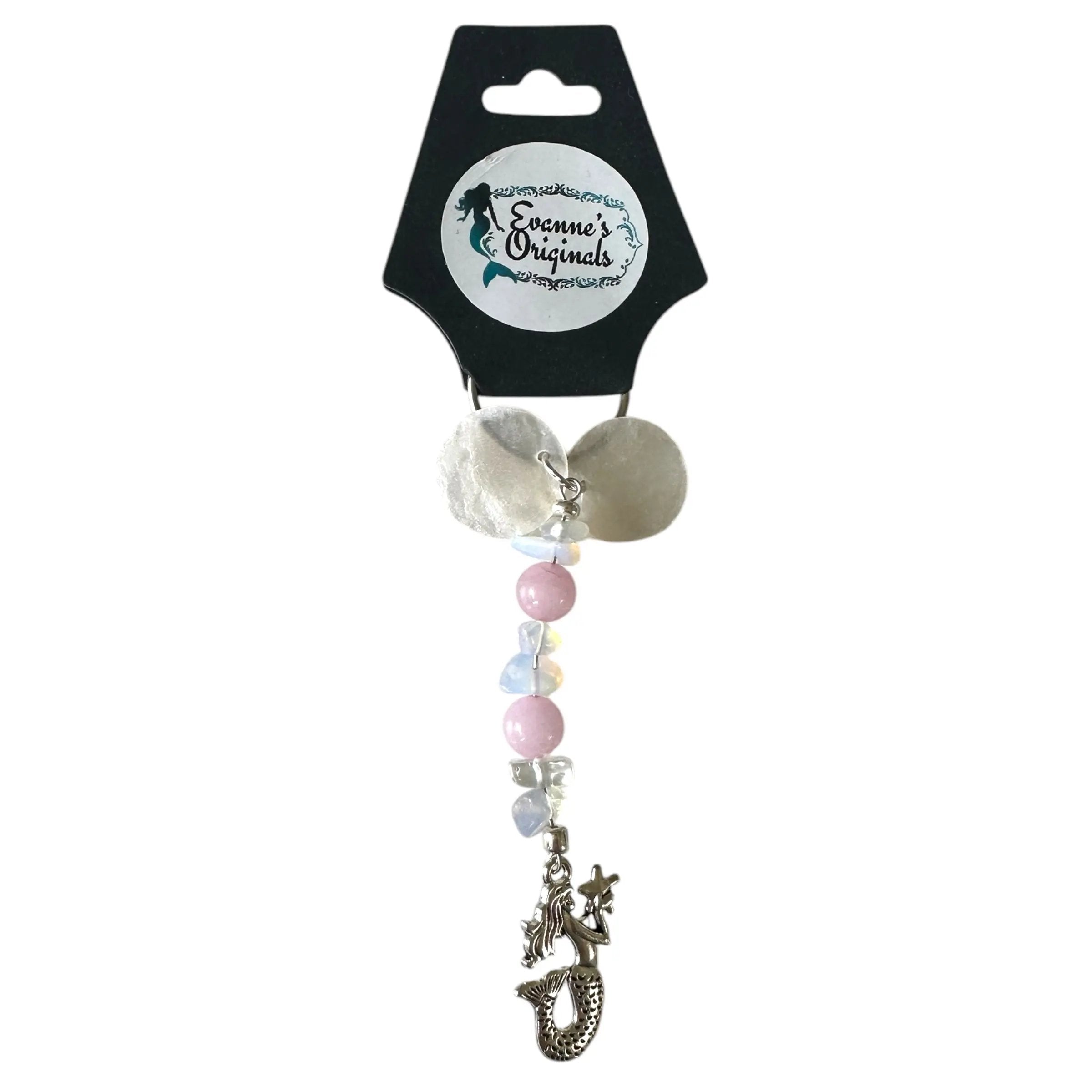 Decorative keychain with seashell and beads on a branded card