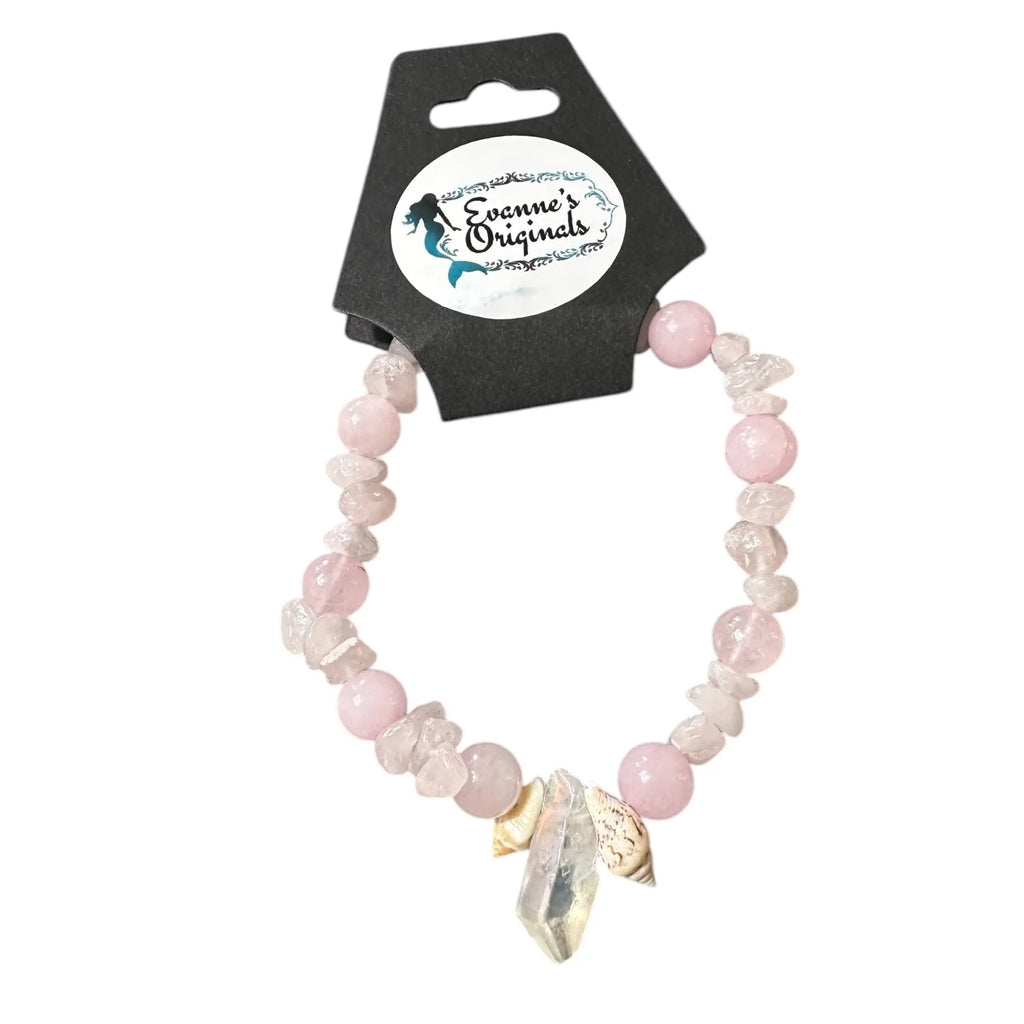 Pink beaded bracelet with a clear crystal charm on a branded card