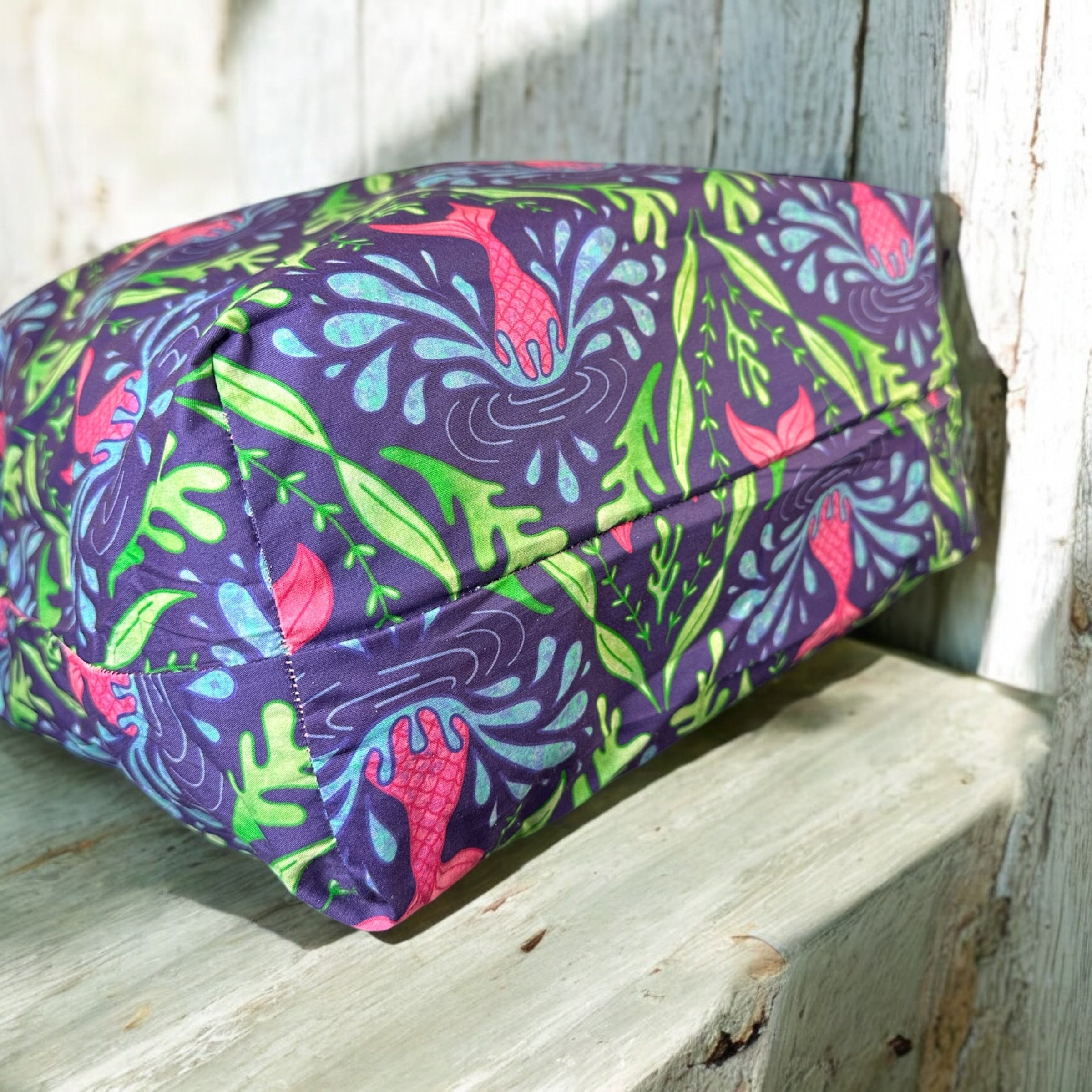 Bottom view of a flat bottom tote bag with mermaid design