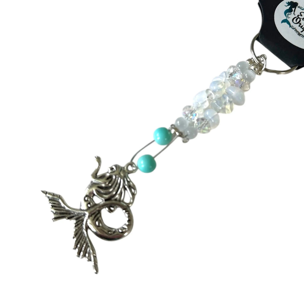 Mermaid charm keychain with beads on a white background