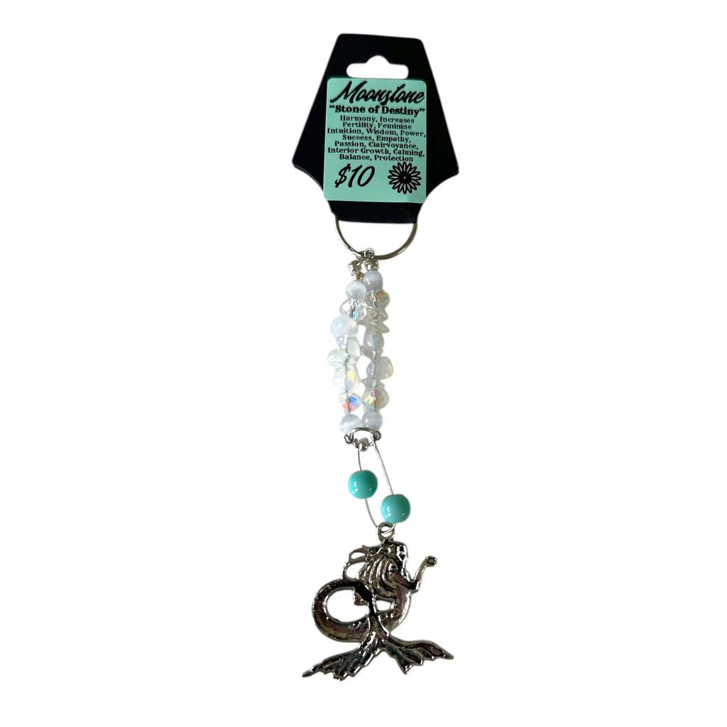 Mermaid tail keychain with beads on a white background