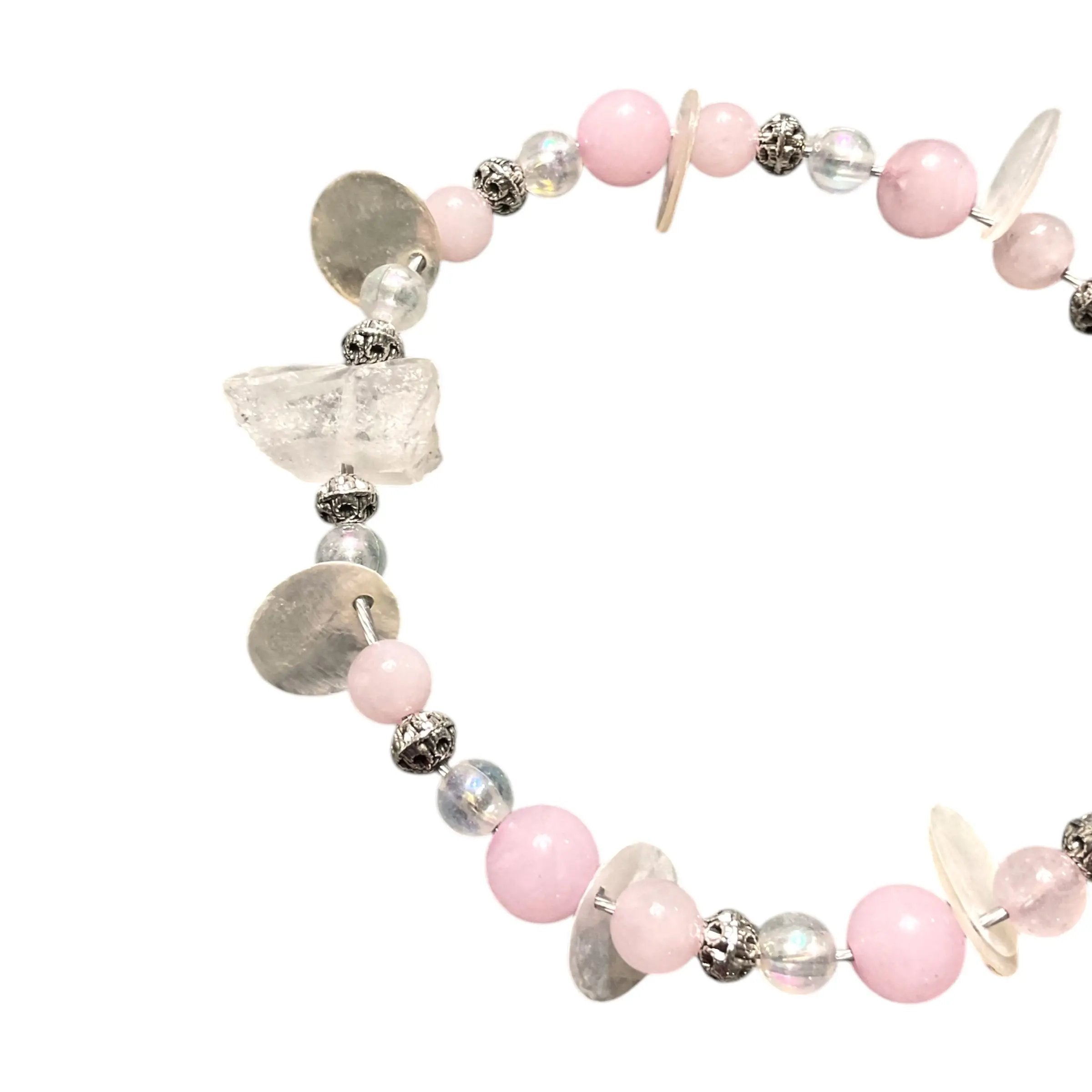 Bracelet with pink beads and silver accents on a white background